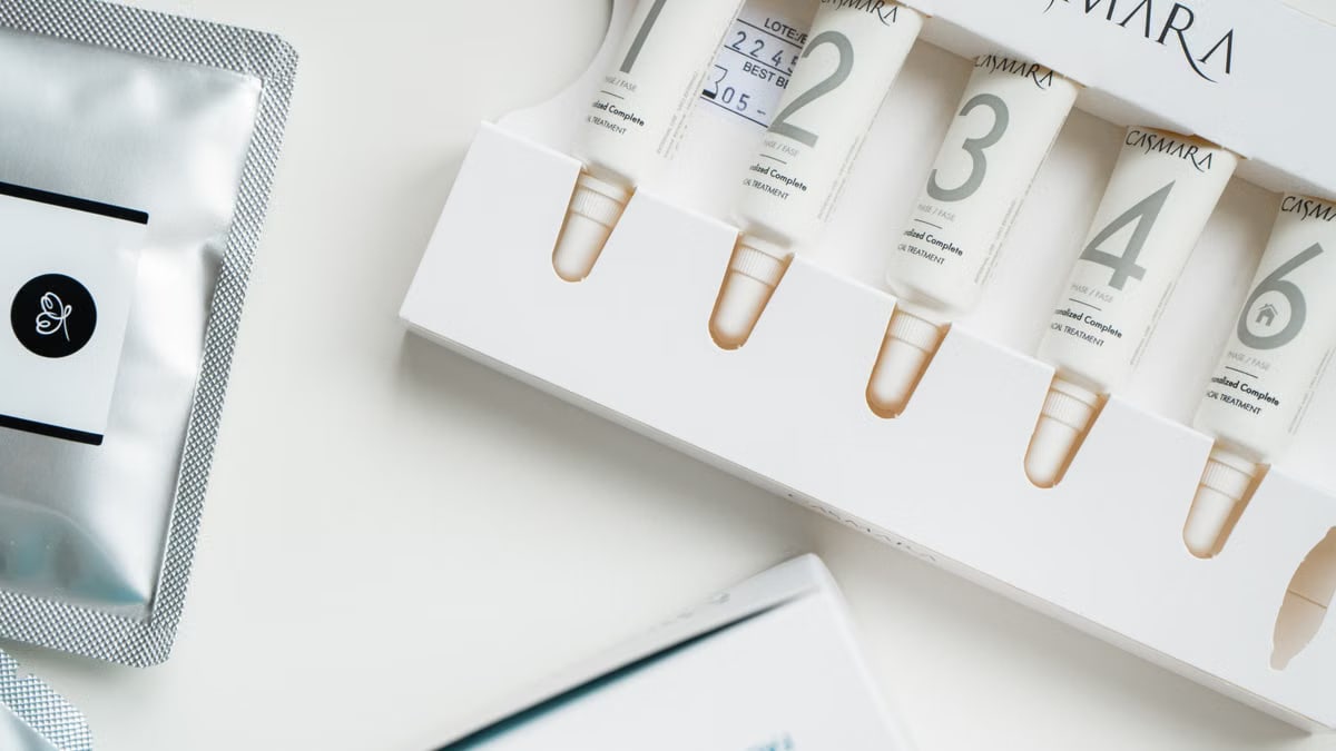 High-angle shot of Casmara beauty products in sleek packaging on a white surface.